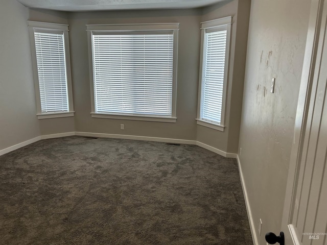 20447 N Glenisla, Boise, ID 83714 - unfurnished room with baseboards, dark carpet, and visible vents