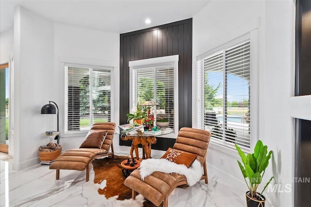 living area featuring wood walls