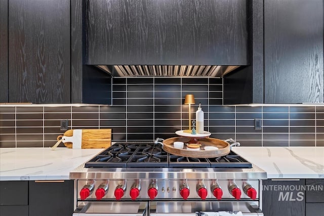 interior details with light stone counters, backsplash, and double oven range