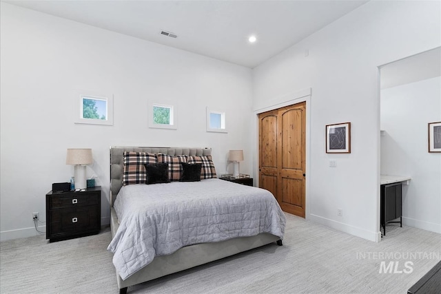 bedroom with light colored carpet