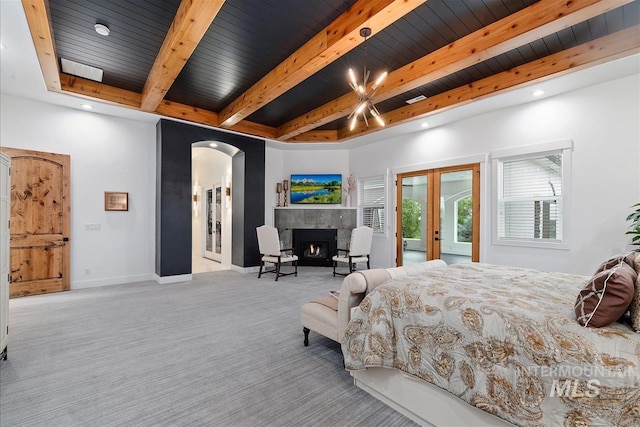 bedroom featuring french doors, wooden ceiling, and light colored carpet