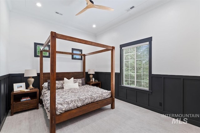 bedroom with light carpet, ceiling fan, and crown molding