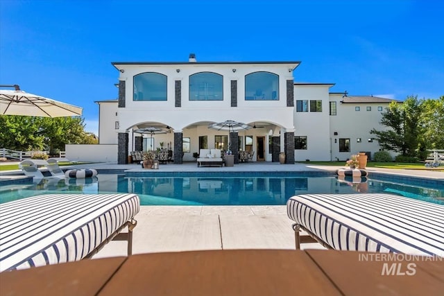 rear view of property with a patio and ceiling fan