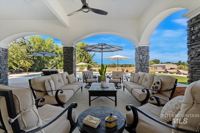 view of patio / terrace with a pool, an outdoor hangout area, and ceiling fan