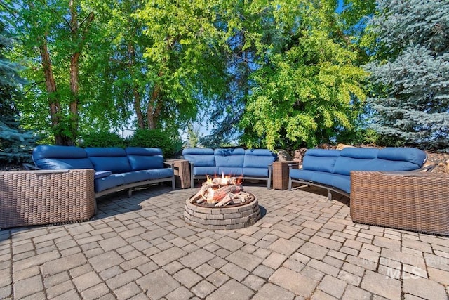 view of patio / terrace with an outdoor living space with a fire pit