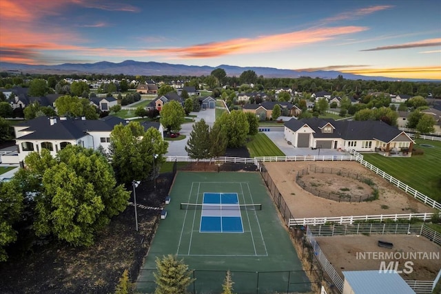 aerial view at dusk featuring a mountain view