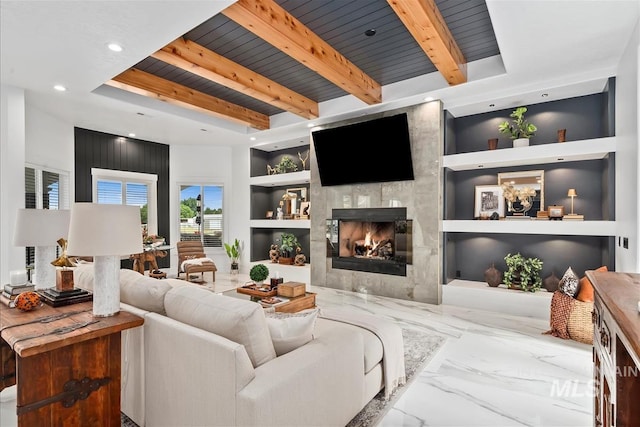 living room featuring a large fireplace, wood ceiling, built in features, and beamed ceiling