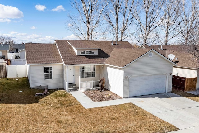 view of front of house with a shingled roof, concrete driveway, a front yard, fence, and a garage