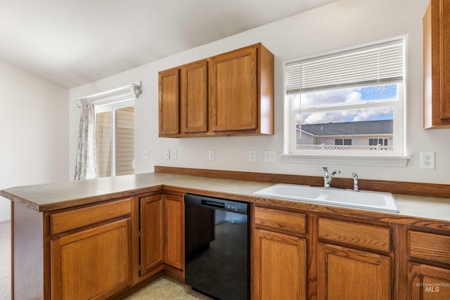 kitchen featuring a peninsula, a sink, black dishwasher, light countertops, and brown cabinets