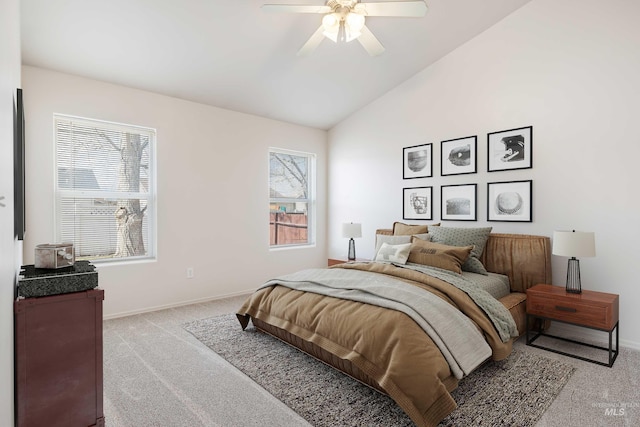 bedroom featuring a ceiling fan, lofted ceiling, light carpet, and baseboards