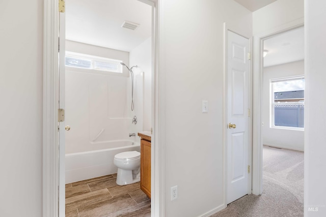 full bathroom with toilet, bathing tub / shower combination, visible vents, and vanity