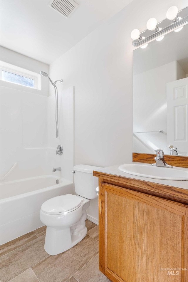 bathroom with visible vents, shower / bathing tub combination, vanity, and toilet