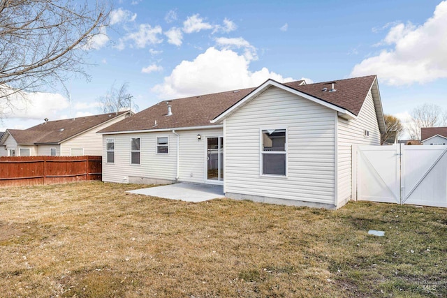 back of property with a yard, a patio area, a fenced backyard, and a gate