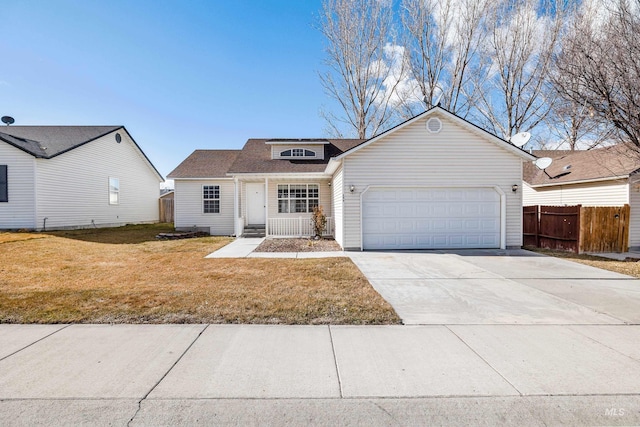 view of front facade with a front lawn, driveway, an attached garage, and fence