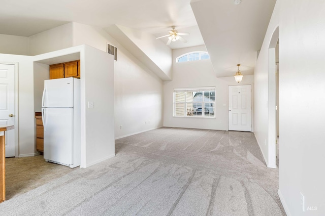 unfurnished living room with ceiling fan, baseboards, visible vents, and light colored carpet