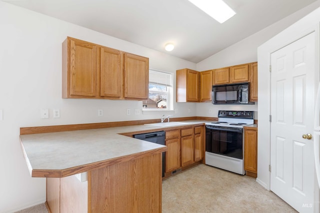 kitchen with lofted ceiling, light countertops, a sink, a peninsula, and black appliances