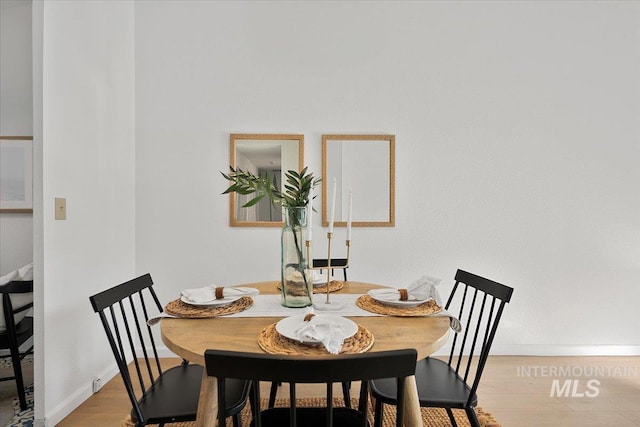 dining room featuring baseboards and wood finished floors