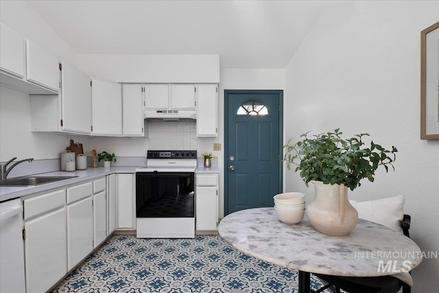 kitchen featuring under cabinet range hood, electric stove, white dishwasher, white cabinetry, and a sink