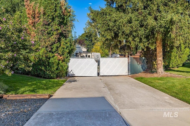 view of gate featuring a yard