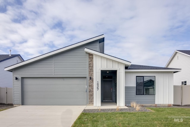 1516 N Coltsfoot Ave, Kuna, ID 83634 - view of front of house featuring board and batten siding, concrete driveway, and a garage