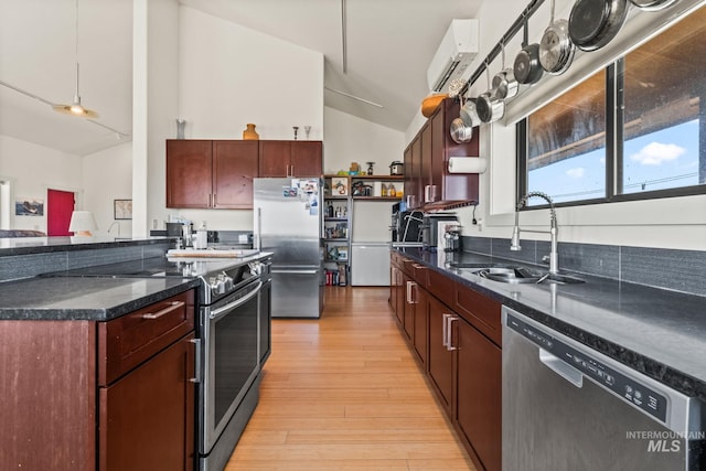 269 N 100 E, Fairfield, ID 83327 - kitchen with stainless steel appliances, open shelves, a sink, vaulted ceiling, and light wood finished floors