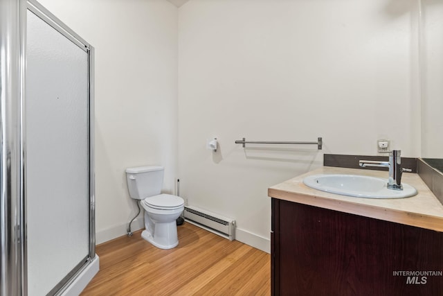 269 N 100 E, Fairfield, ID 83327 - full bath featuring a baseboard heating unit, a stall shower, vanity, toilet, and wood finished floors