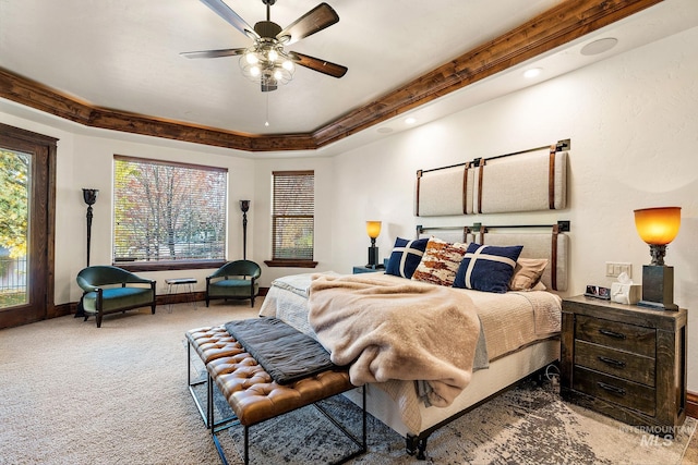 carpeted bedroom featuring ceiling fan, multiple windows, and access to exterior