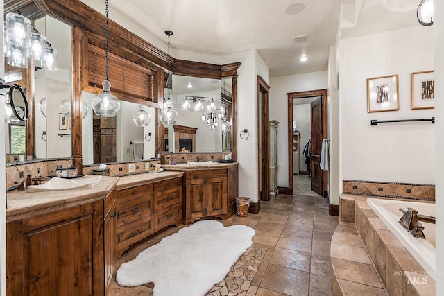 bathroom featuring vanity and a relaxing tiled tub