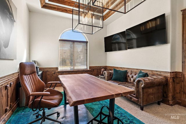 dining space featuring a notable chandelier, a healthy amount of sunlight, and light colored carpet