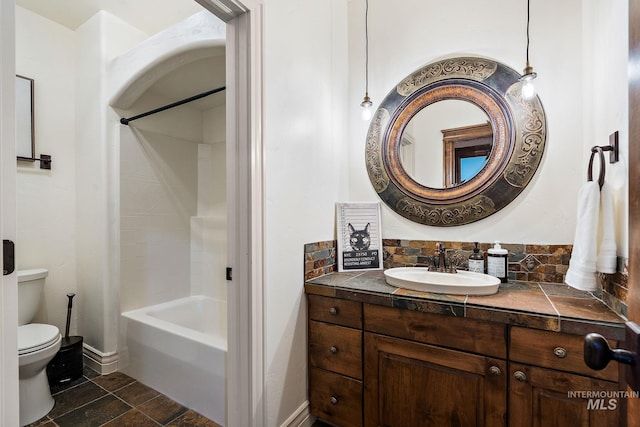 full bathroom featuring toilet, bathtub / shower combination, tasteful backsplash, and vanity