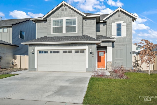 view of front of house featuring a front lawn and a garage