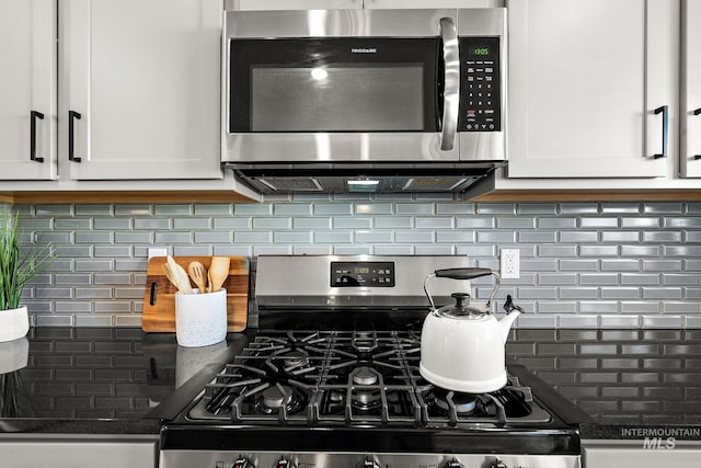 kitchen featuring white cabinets, backsplash, and appliances with stainless steel finishes