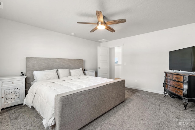 bedroom with ceiling fan and dark carpet