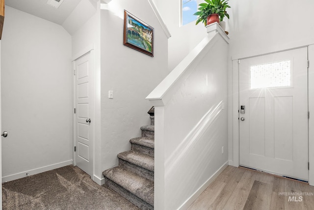 foyer entrance featuring vaulted ceiling