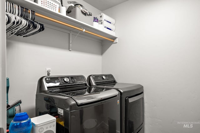 clothes washing area with independent washer and dryer