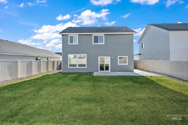 rear view of property featuring a patio area and a yard