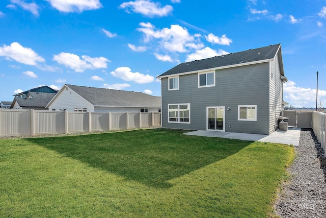 rear view of house featuring central AC, a yard, and a patio