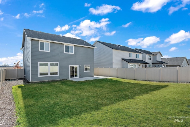 rear view of house featuring a patio and a yard