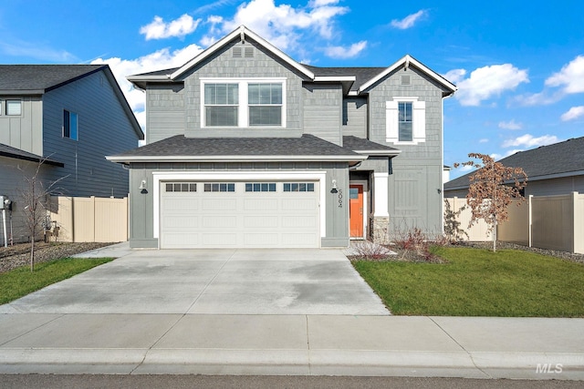 view of front of home featuring a garage and a front lawn