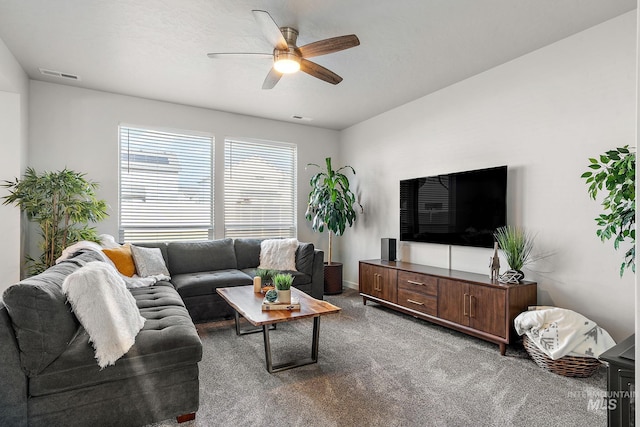 living room with ceiling fan and carpet flooring