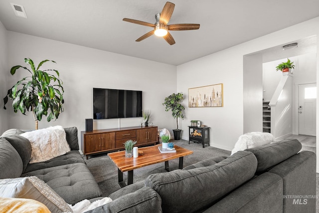 living room with carpet floors and ceiling fan