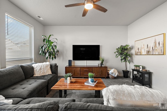 carpeted living room featuring ceiling fan