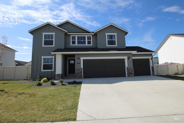 view of front of home with fence, board and batten siding, a front yard, and an attached garage