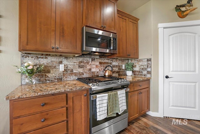 628 Pioneer Mountain Loop, Jerome, ID 83338 - kitchen featuring appliances with stainless steel finishes, light stone counters, backsplash, and dark wood finished floors