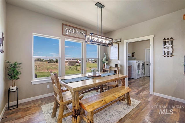 628 Pioneer Mountain Loop, Jerome, ID 83338 - dining space with washing machine and dryer, baseboards, wood finished floors, and a chandelier