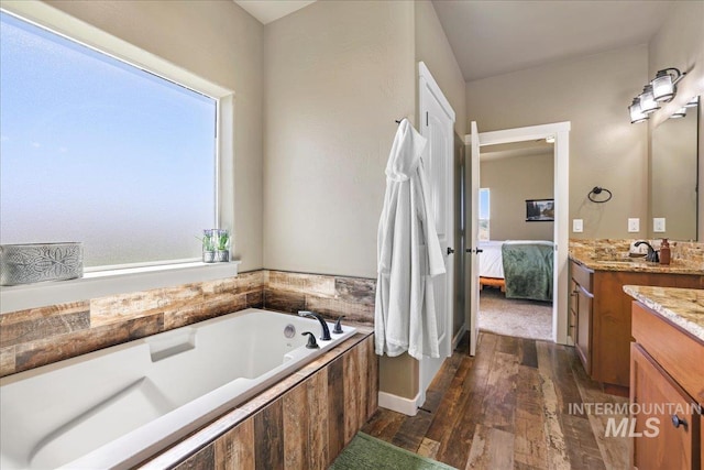 628 Pioneer Mountain Loop, Jerome, ID 83338 - ensuite bathroom featuring vanity, a garden tub, and hardwood / wood-style floors