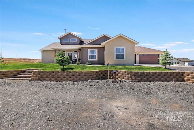 628 Pioneer Mountain Loop, Jerome, ID 83338 - view of front of house with an attached garage, concrete driveway, board and batten siding, and a front yard