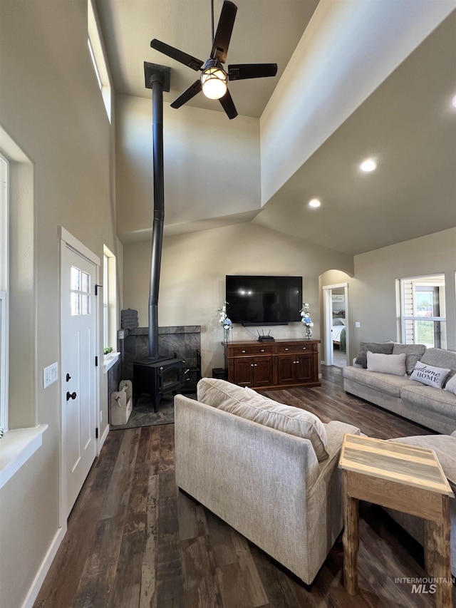 628 Pioneer Mountain Loop, Jerome, ID 83338 - living room with a wood stove, a towering ceiling, ceiling fan, dark wood-style flooring, and arched walkways
