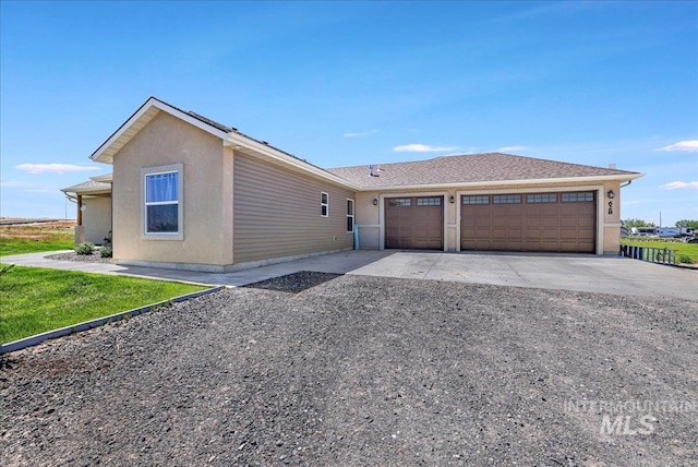 628 Pioneer Mountain Loop, Jerome, ID 83338 - view of front facade with driveway, an attached garage, and stucco siding