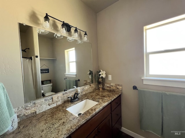 628 Pioneer Mountain Loop, Jerome, ID 83338 - bathroom with toilet, vanity, curtained shower, and baseboards